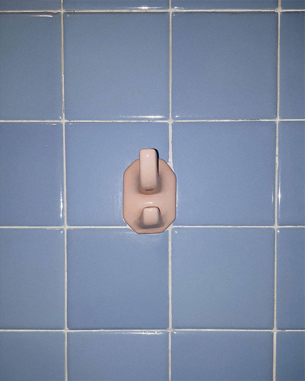 A double hook made of stoneware, pink enamel, fixed to a wall. Found on a private home in Mexico City, Mexico, 2018.