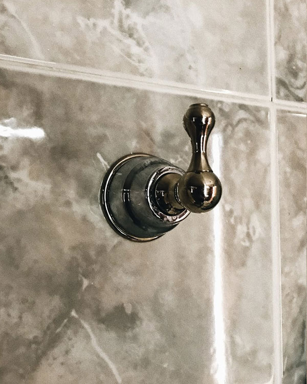 A single hook made of metal, chrome, fixed to a wall. Found on a private home in Acapulco, Mexico, 2022.