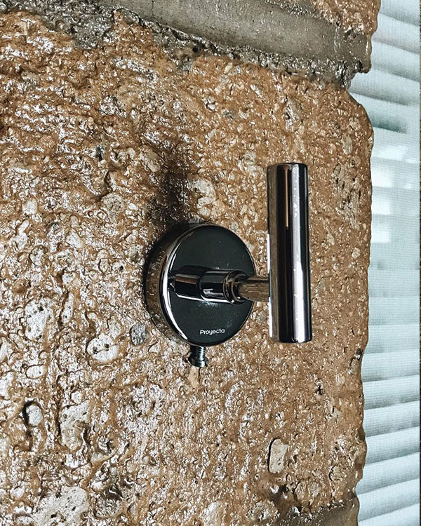 A single hook made of metal, chrome, fixed to a wall. Found on a private home in Aguascalientes, Mexico, 2022.