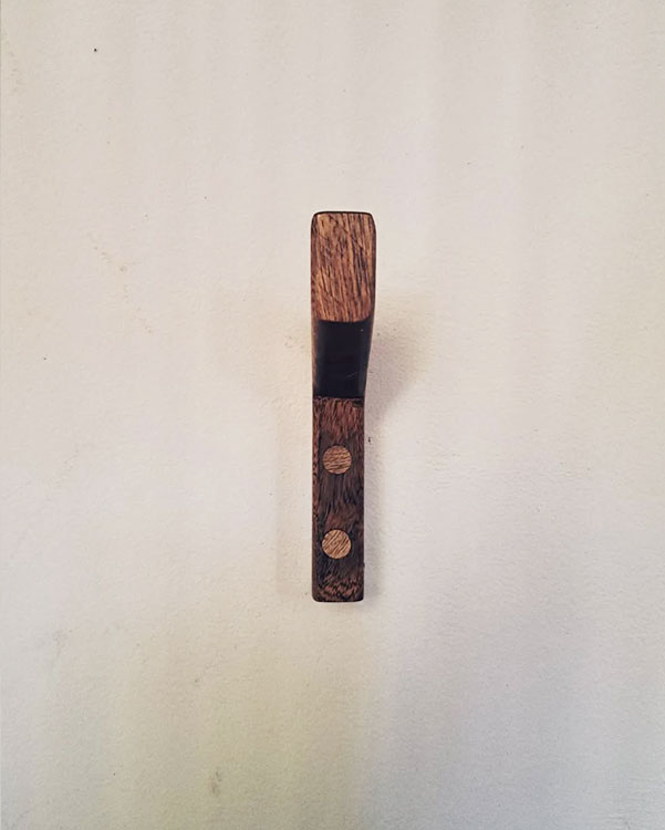 A single hook made of wood, fixed to a wall. Found on a private home in Puerto Escondido, Mexico, 2024.