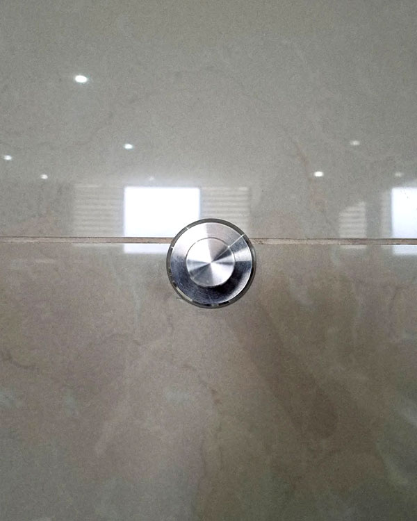 A single hook made of metal, nickel, fixed to a wall. Found on a Sport Club in Mexico City, Mexico, 2024.